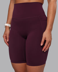 Woman wearing Elixir Ultra High-Rise 9" Short Pockets - Cherry Lacquer | Model:Lyss | Size:S