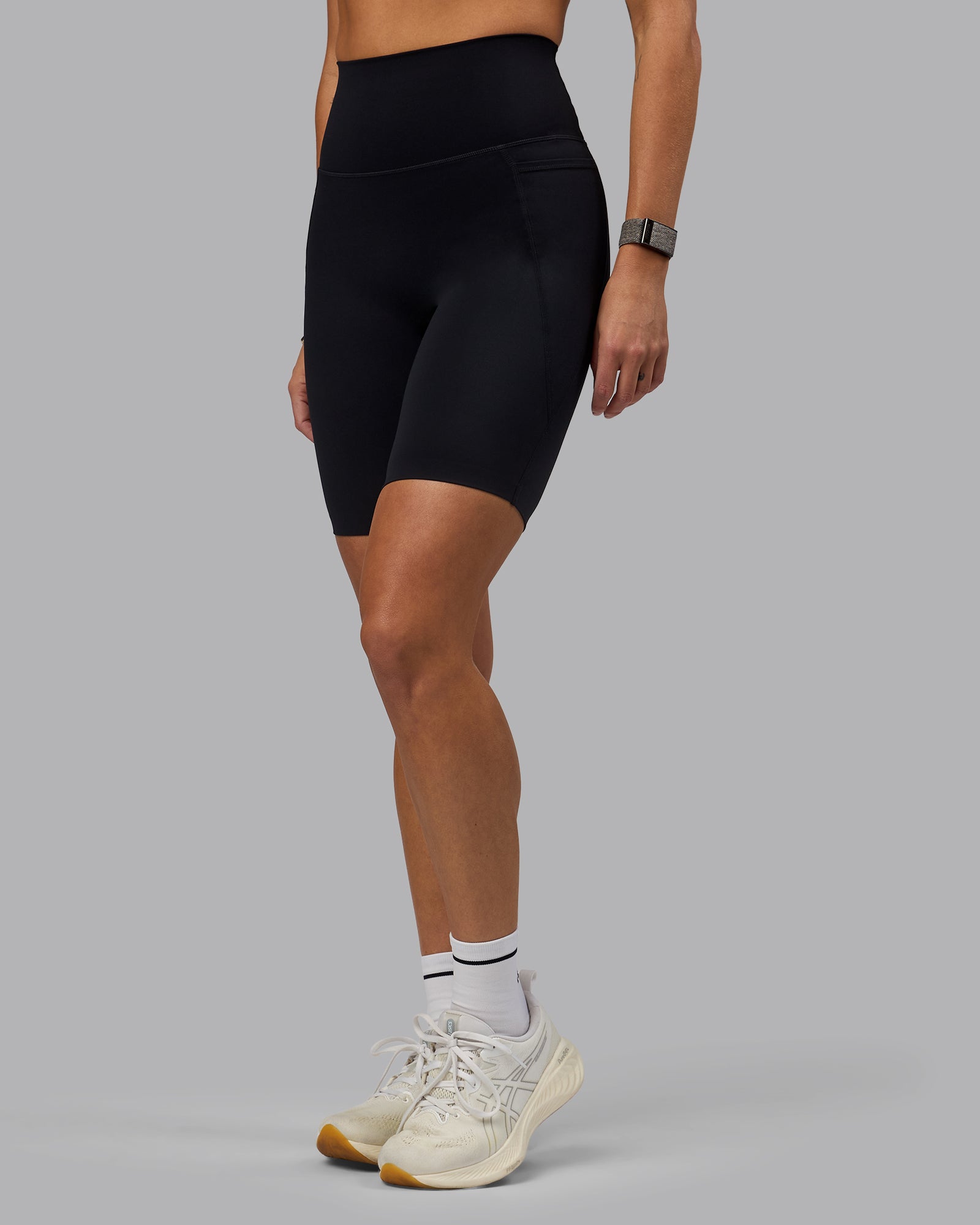 Woman wearing Elixir Ultra High-Rise 9" Short Pockets - Black | Model:Shae | Size:S