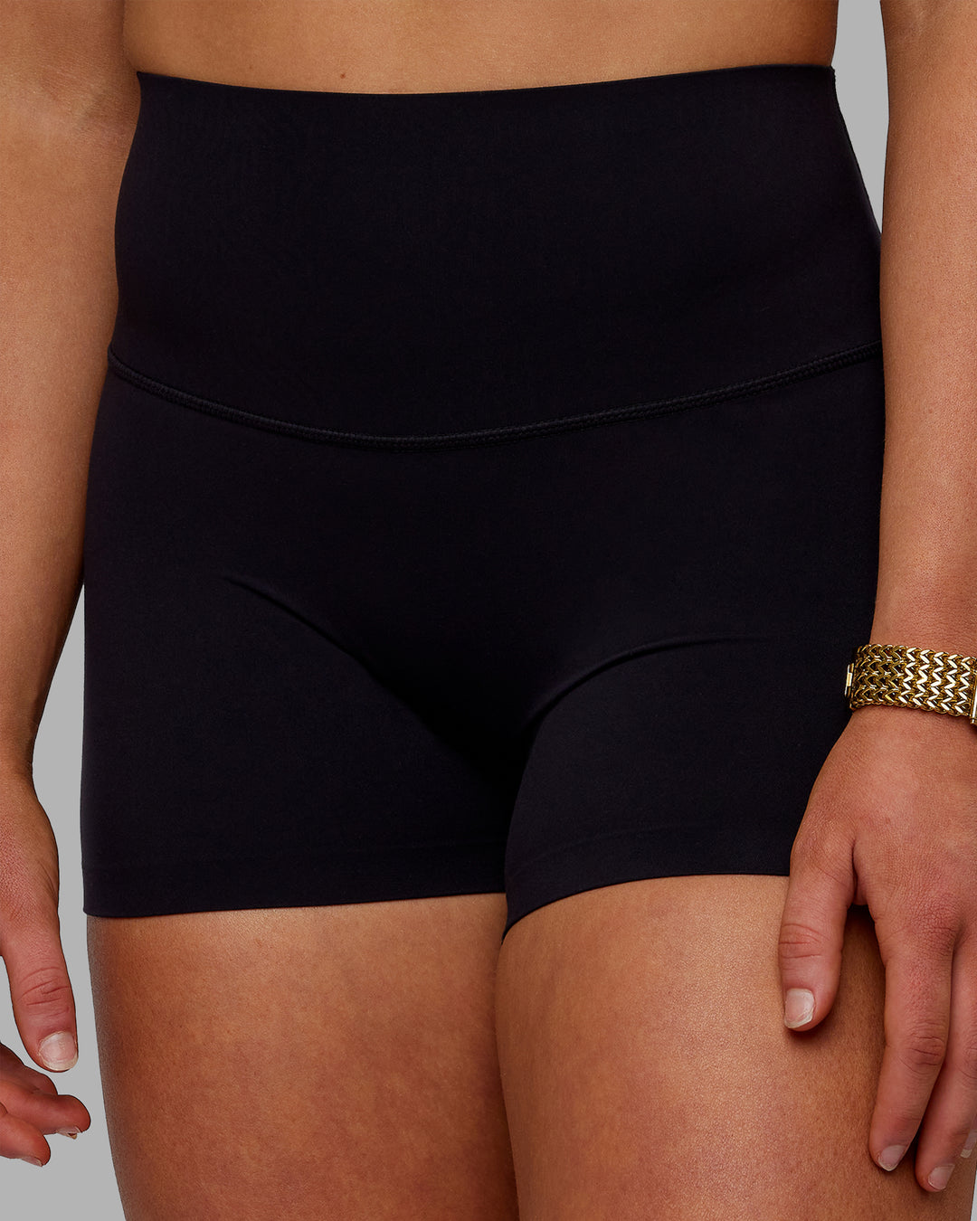 Woman wearing Elixir Ultra High-Rise Bonded Waistband 4" Short - Black | Model:Caitlin | Size:S
