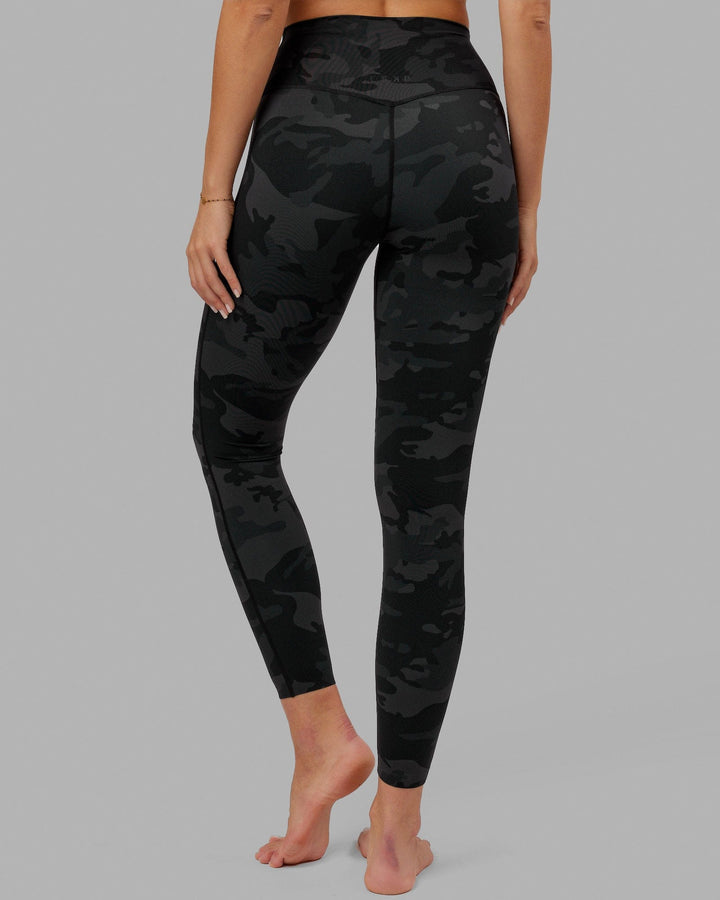 Woman wearing Elixir Full Length Tight - Black Camo
