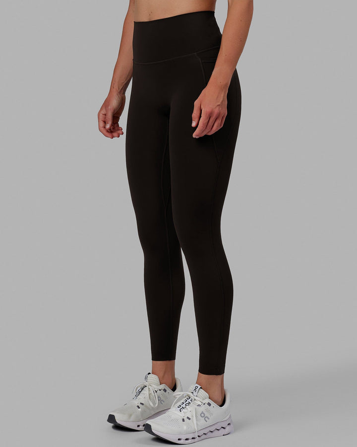 Woman wearing Elixir Full Length Tights With Pockets - Dark Walnut