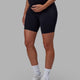 Woman wearing Elixir Mid Short Maternity Tight - Black
