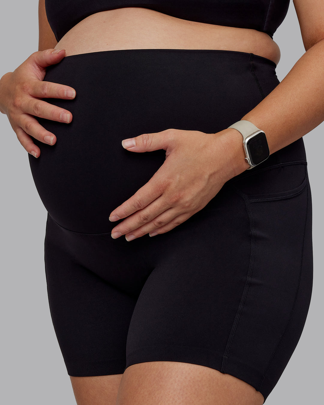 Woman wearing Elixir Ultra High-Rise Maternity 6&quot; Short Pockets - Black | Model:Nevada | Size:M