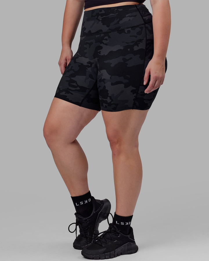 Woman wearing Elixir Mid Short Tight - Black Camo