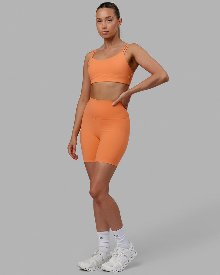 Woman wearing Elixir Mid Short Tights - Tangerine