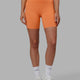 Woman wearing Elixir Mid Short Tights - Tangerine
