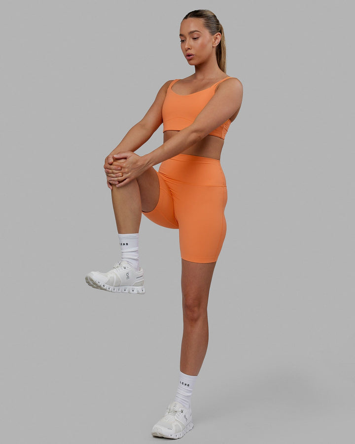 Woman wearing Elixir Mid Short Tights - Tangerine