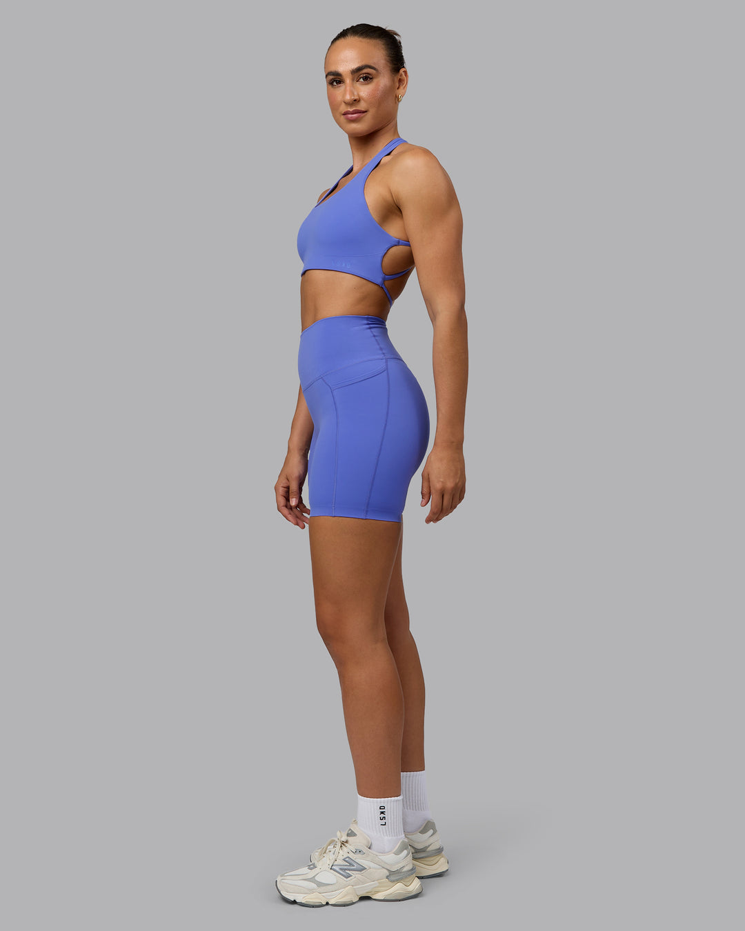 Woman wearing Elixir Ultra High-Rise 6&quot; Short Pockets - Baja Blue
