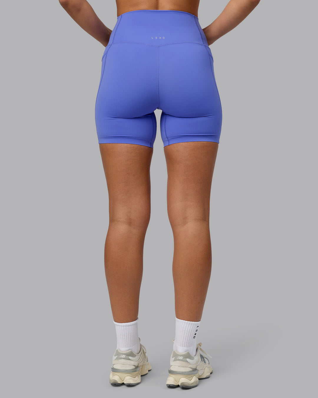 Woman wearing Elixir Ultra High-Rise 6&quot; Short Pockets - Baja Blue