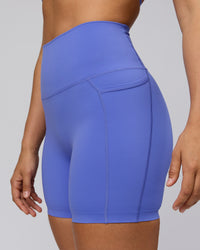 Woman wearing Elixir Ultra High-Rise 6" Short Pockets - Baja Blue