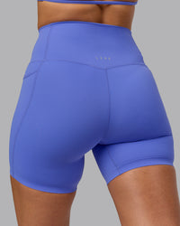 Woman wearing Elixir Ultra High-Rise 6" Short Pockets - Baja Blue