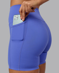 Woman wearing Elixir Ultra High-Rise 6" Short Pockets - Baja Blue