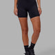 Woman wearing Elixir Mid Short Tight with Pockets - Black