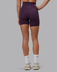 Woman wearing Elixir Ultra High-Rise 6" Short Pockets - Midnight Plum