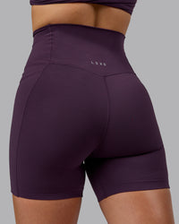 Woman wearing Elixir Ultra High-Rise 6" Short Pockets - Midnight Plum