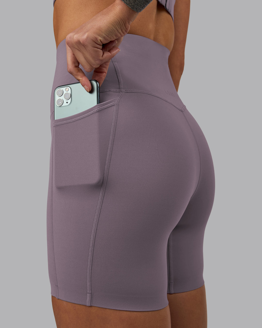 Woman wearing Elixir Ultra High-Rise 6&quot; Short Pockets - Purple Sage