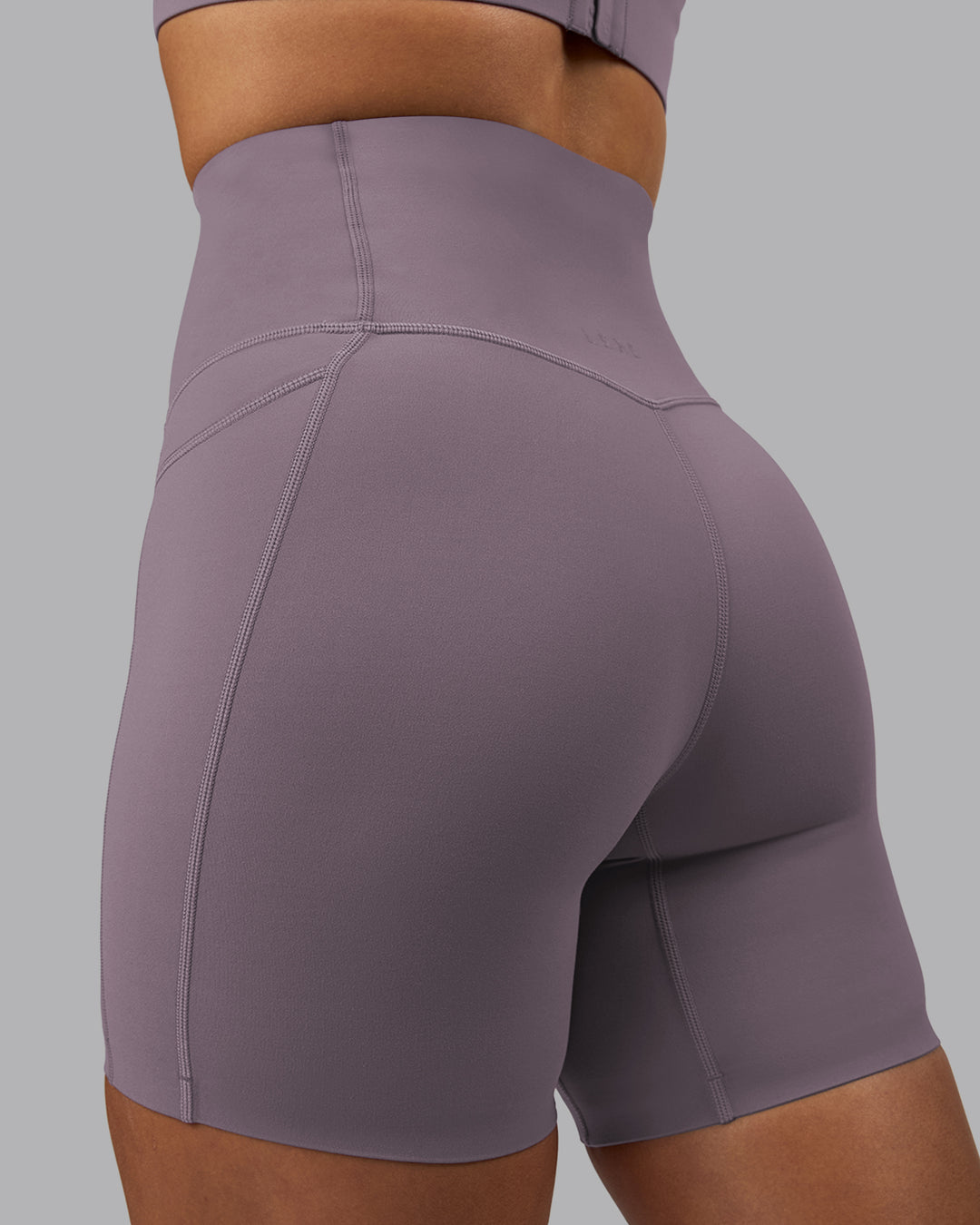 Woman wearing Elixir Ultra High-Rise 6&quot; Short Pockets - Purple Sage