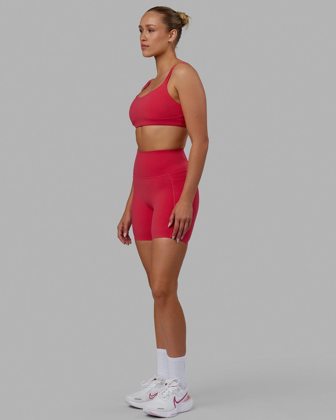 Woman wearing Elixir Mid Short Tights with Pockets - Raspberry