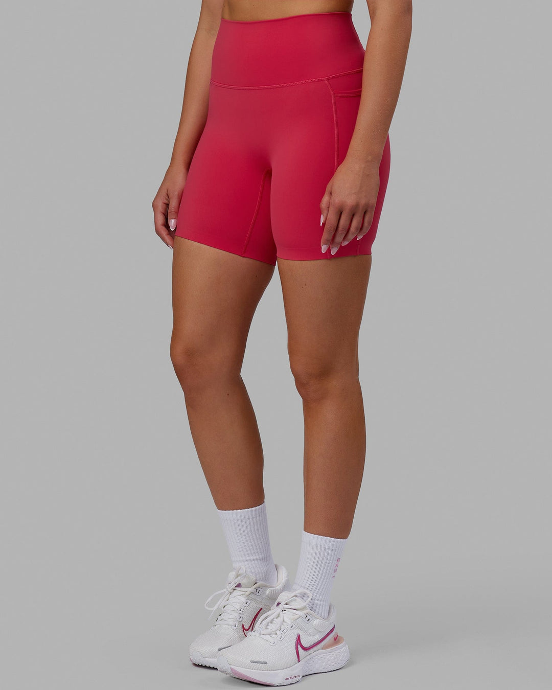 Woman wearing Elixir Mid Short Tights with Pockets - Raspberry