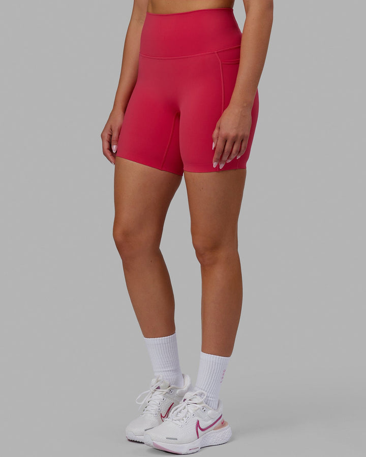 Woman wearing Elixir Mid Short Tights with Pockets - Raspberry