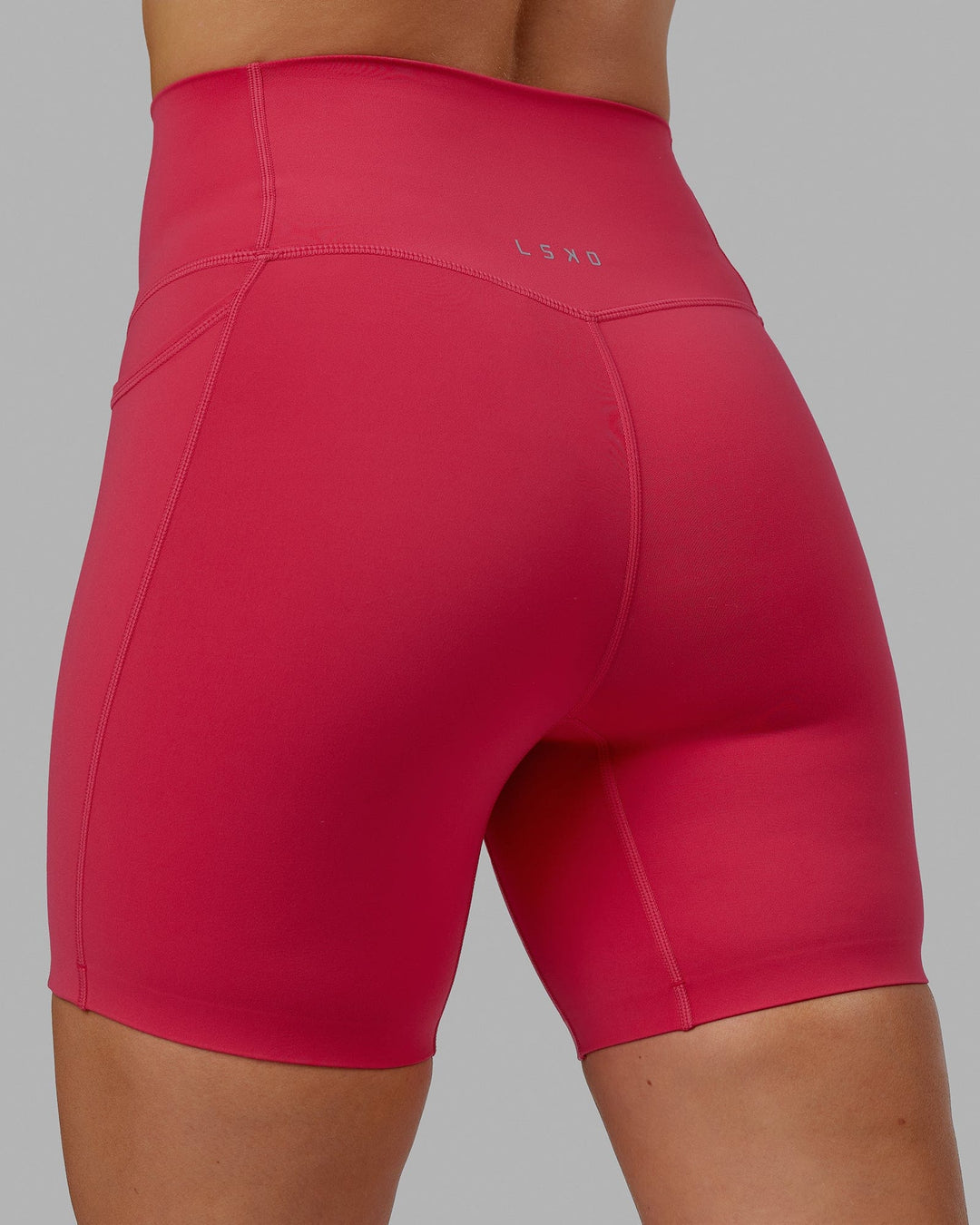Woman wearing Elixir Mid Short Tights with Pockets - Raspberry