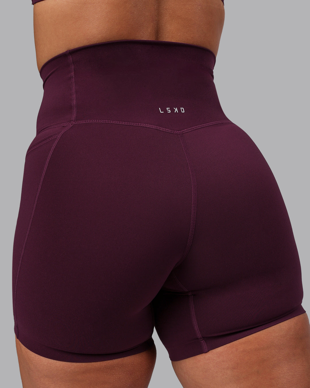 Woman wearing Elixir Ultra High-Rise 6" Short Pockets - Cherry Lacquer