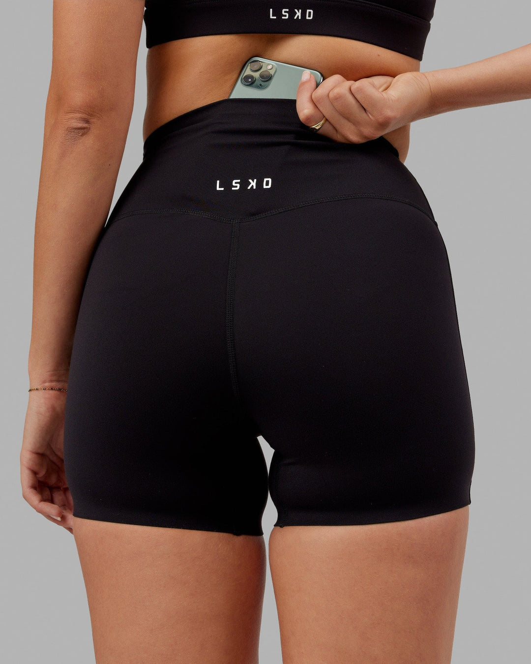 Woman wearing Elixir Ultra High-Rise 4&quot; Short - Black | Model:Chelsea | Size:S