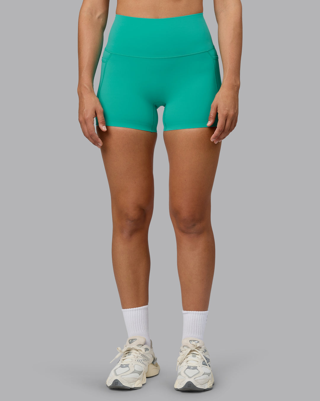 Woman wearing Elixir Ultra High-Rise 4&quot; Short Pockets - Atlantis | Model:Sophie | Size:S
