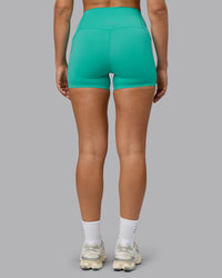 Woman wearing Elixir Ultra High-Rise 4" Short Pockets - Atlantis | Model:Sophie | Size:S
