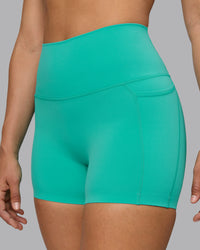 Woman wearing Elixir Ultra High-Rise 4" Short Pockets - Atlantis | Model:Sophie | Size:S