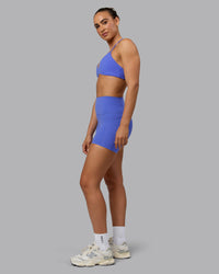 Woman wearing Elixir Ultra High-Rise 4" Short Pockets - Baja Blue | Model:Sophie | Size:S