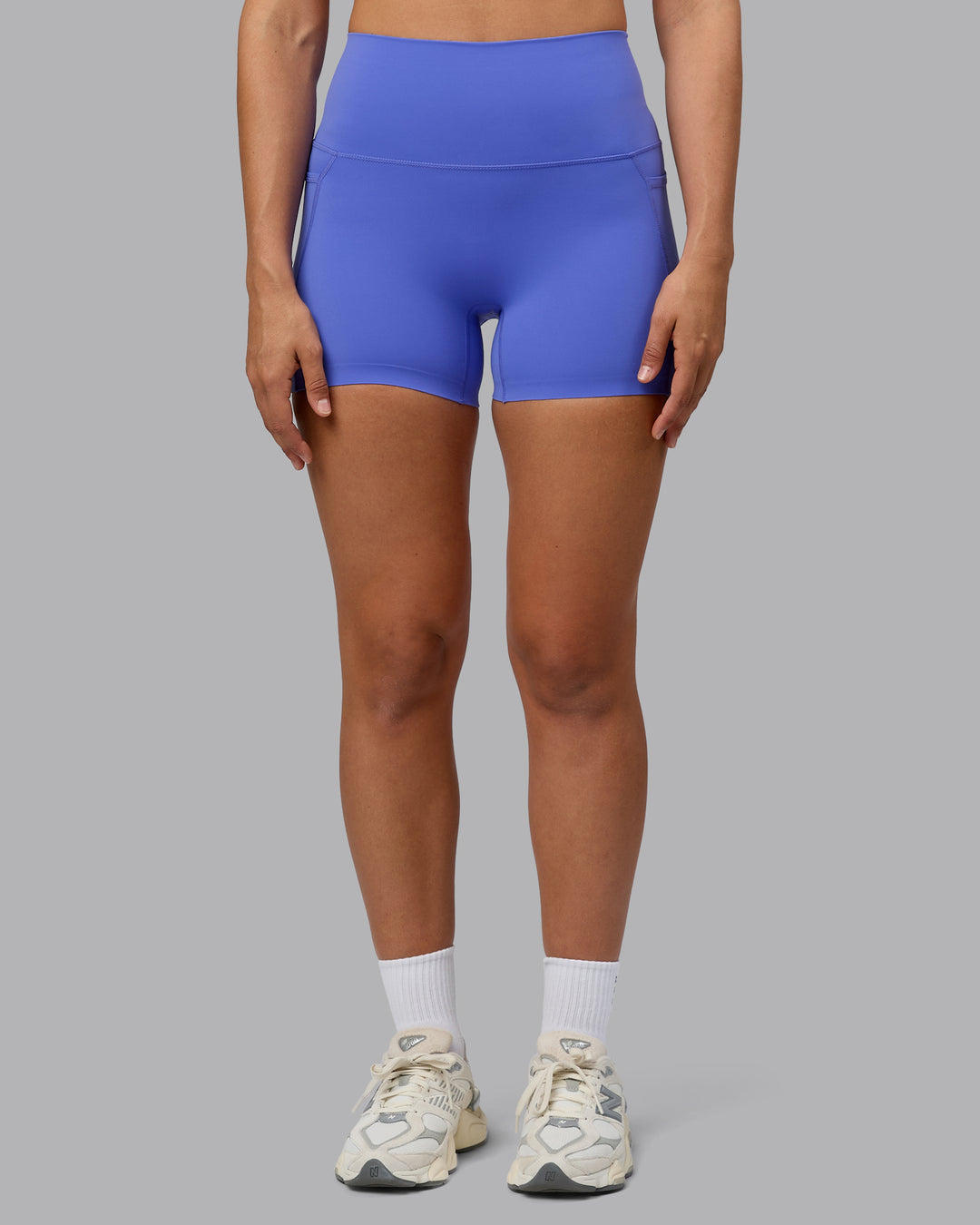 Woman wearing Elixir Ultra High-Rise 4" Short Pockets - Baja Blue | Model:Sophie | Size:S