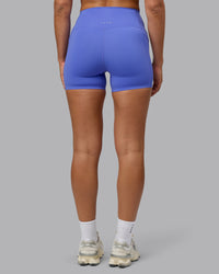 Woman wearing Elixir Ultra High-Rise 4" Short Pockets - Baja Blue | Model:Sophie | Size:S