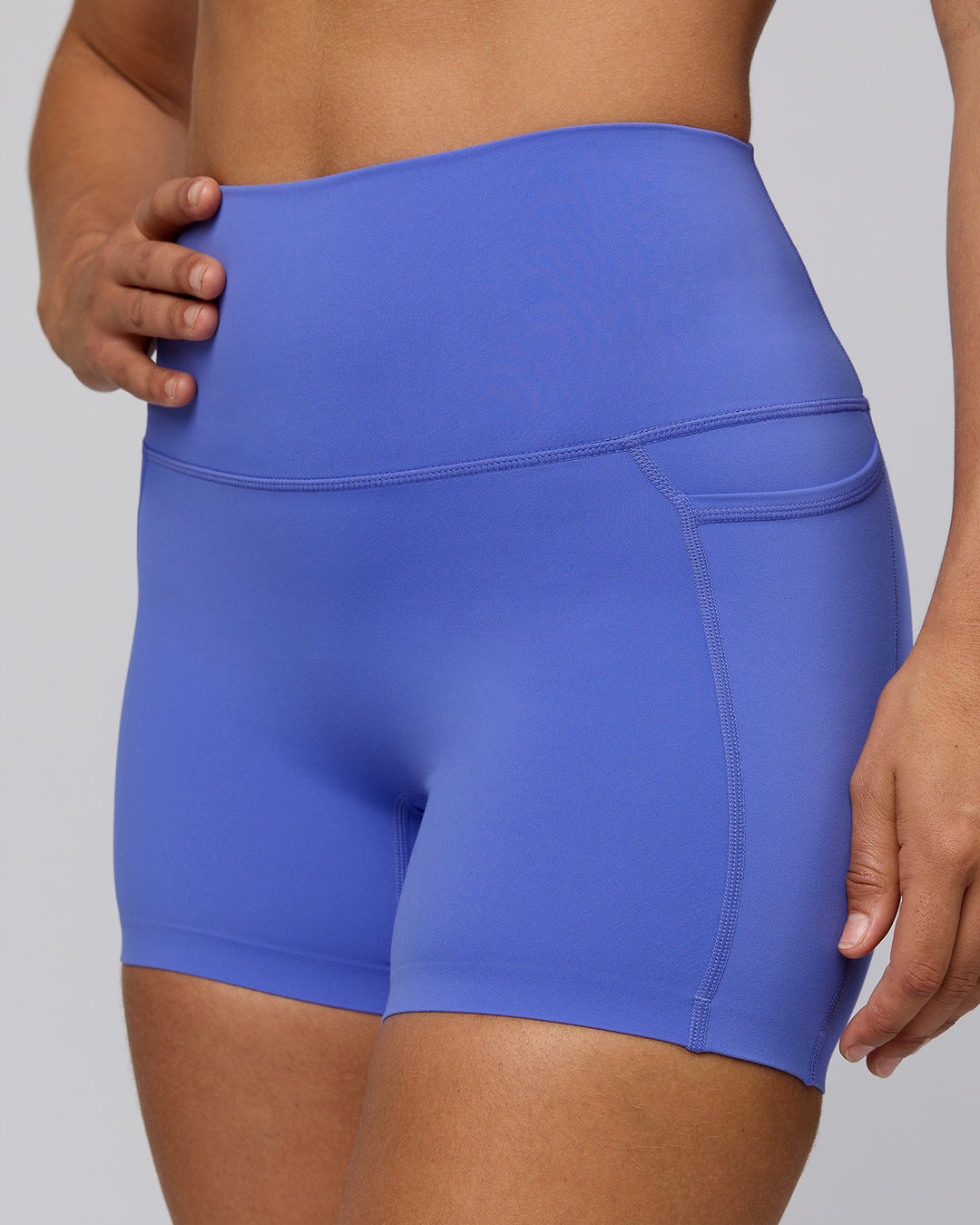 Woman wearing Elixir Ultra High-Rise 4" Short Pockets - Baja Blue | Model:Sophie | Size:S