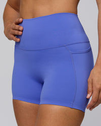 Woman wearing Elixir Ultra High-Rise 4" Short Pockets - Baja Blue | Model:Sophie | Size:S