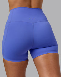 Woman wearing Elixir Ultra High-Rise 4" Short Pockets - Baja Blue | Model:Sophie | Size:S