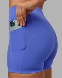 Woman wearing Elixir Ultra High-Rise 4" Short Pockets - Baja Blue | Model:Sophie | Size:S