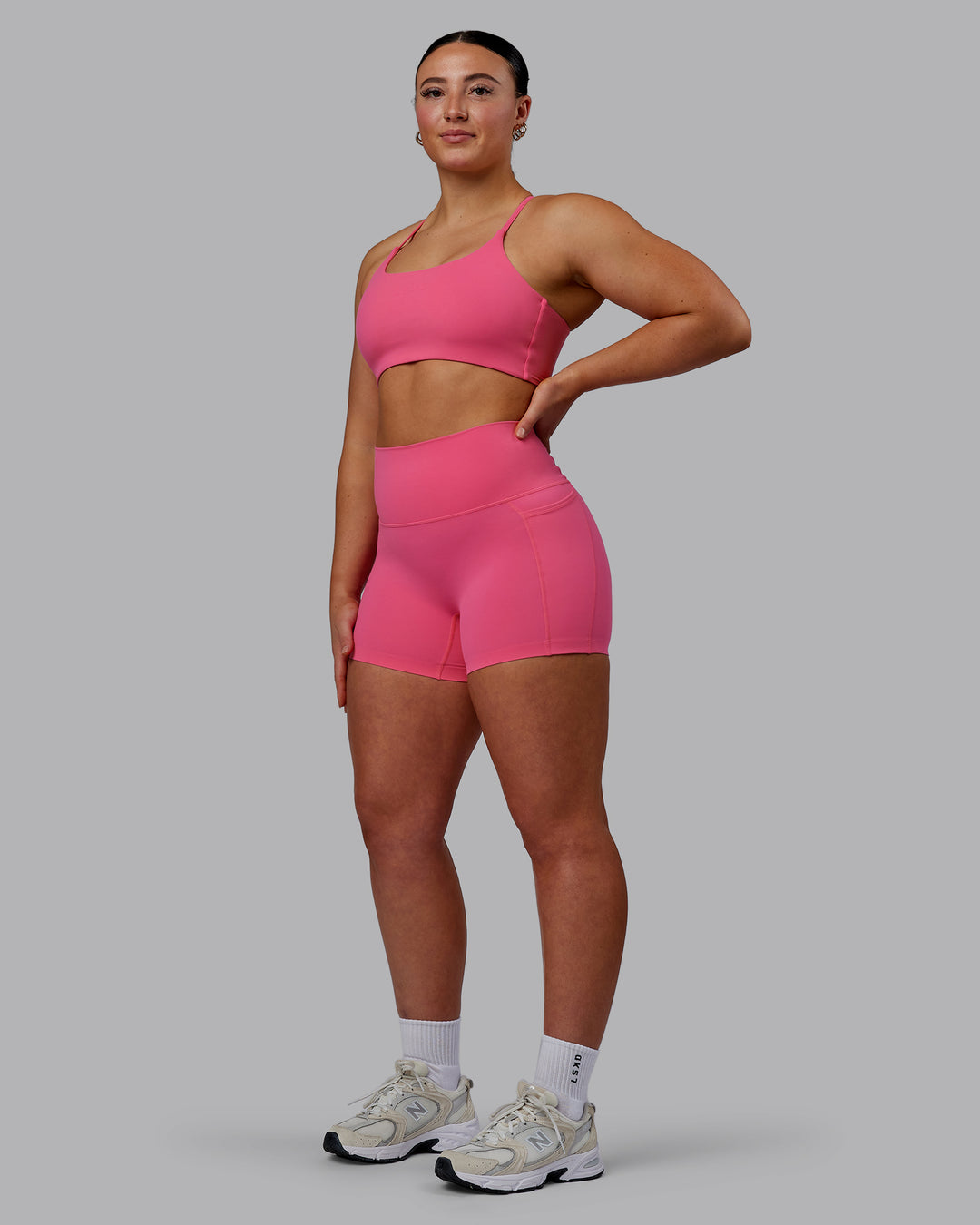 Woman wearing Elixir Ultra High-Rise 4&quot; Short Pockets - Carmine Rose | Model:Bronty | Size:M