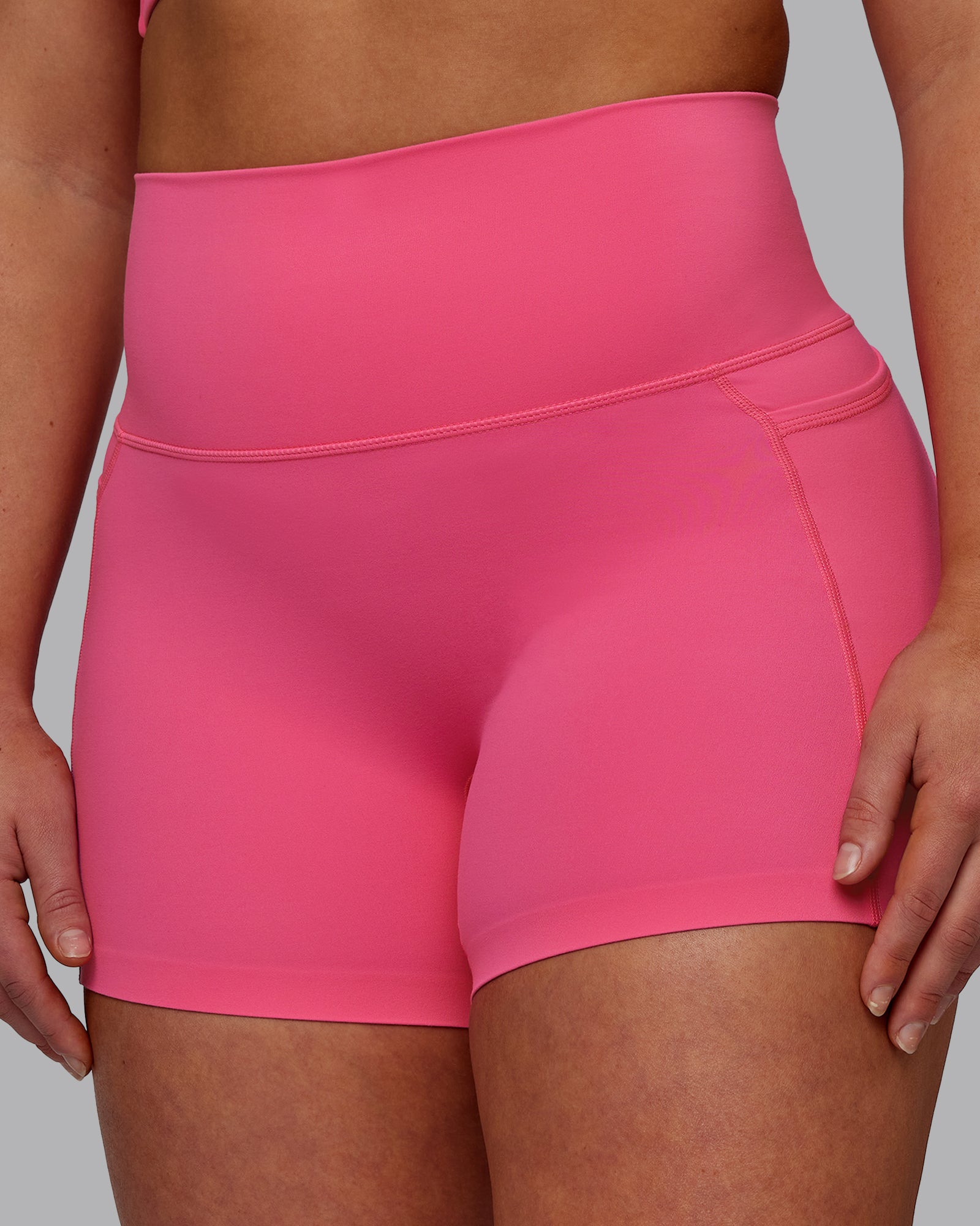 Woman wearing Elixir Ultra High-Rise 4" Short Pockets - Carmine Rose | Model:Bronty | Size:M