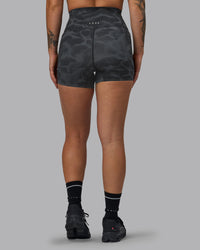 Woman wearing Elixir Ultra High-Rise 4" Short Pockets - Tranquil-Black | Model:Robyn | Size:S