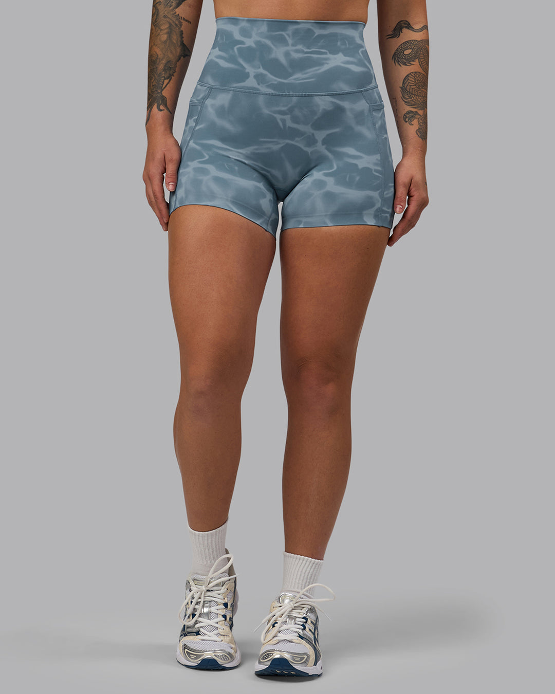 Woman wearing Elixir Ultra High-Rise 4" Short Pockets - Tranquil-Elemental Blue | Model:Robyn | Size:S