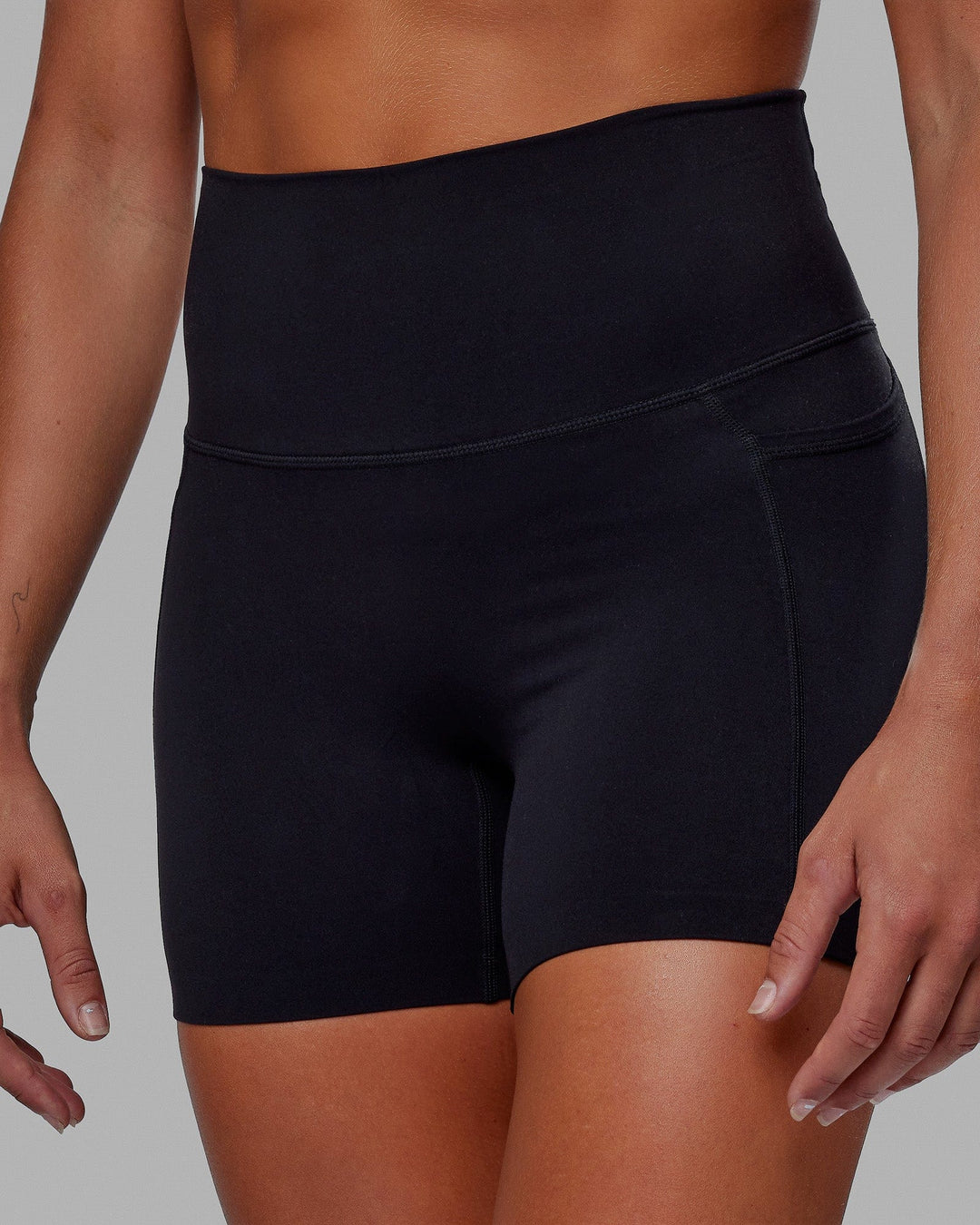 Woman wearing Elixir Ultra High-Rise 4" Short Pockets - Black | Model:Katie | Size:S