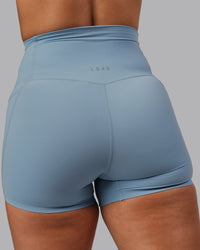 Woman wearing Elixir Ultra High-Rise 4" Short Pockets - Glacier Lake | Model:Lyss | Size:S