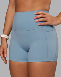 Woman wearing Elixir Ultra High-Rise 4" Short Pockets - Glacier Lake | Model:Lyss | Size:S