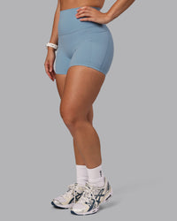 Woman wearing Elixir Ultra High-Rise 4" Short Pockets - Glacier Lake | Model:Lyss | Size:S