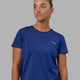 Woman wearing Endeavour FLX Cotton Tee - Galactic Cobalt-White