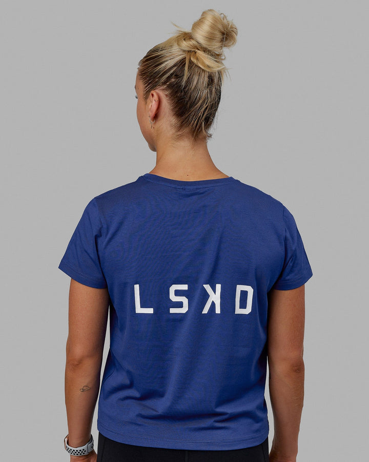 Woman wearing Endeavour FLX Cotton Tee - Galactic Cobalt-White