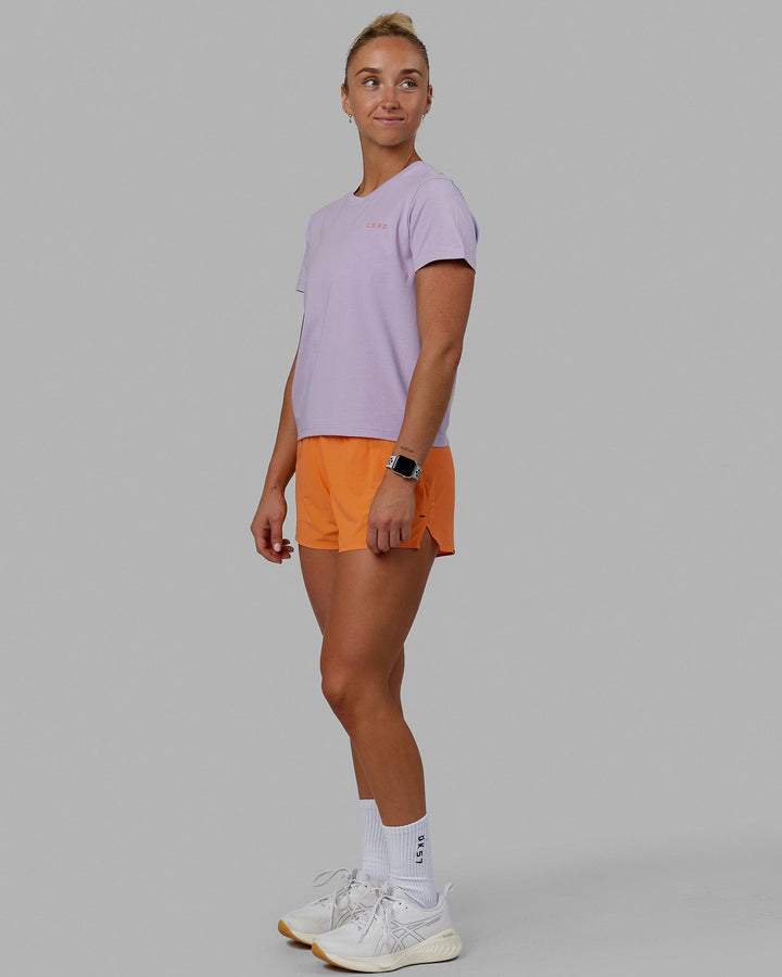 Woman wearing Endeavour FLX Cotton Tee - Pale Lilac-Impact Orange