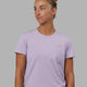 Woman wearing Endeavour FLX Cotton Tee - Pale Lilac-Impact Orange