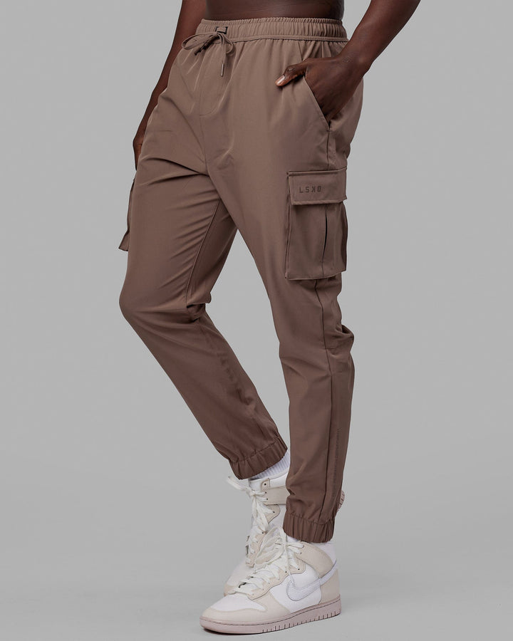 Woman wearing Energy Stretch Performance Cargo Joggers - Deep Taupe